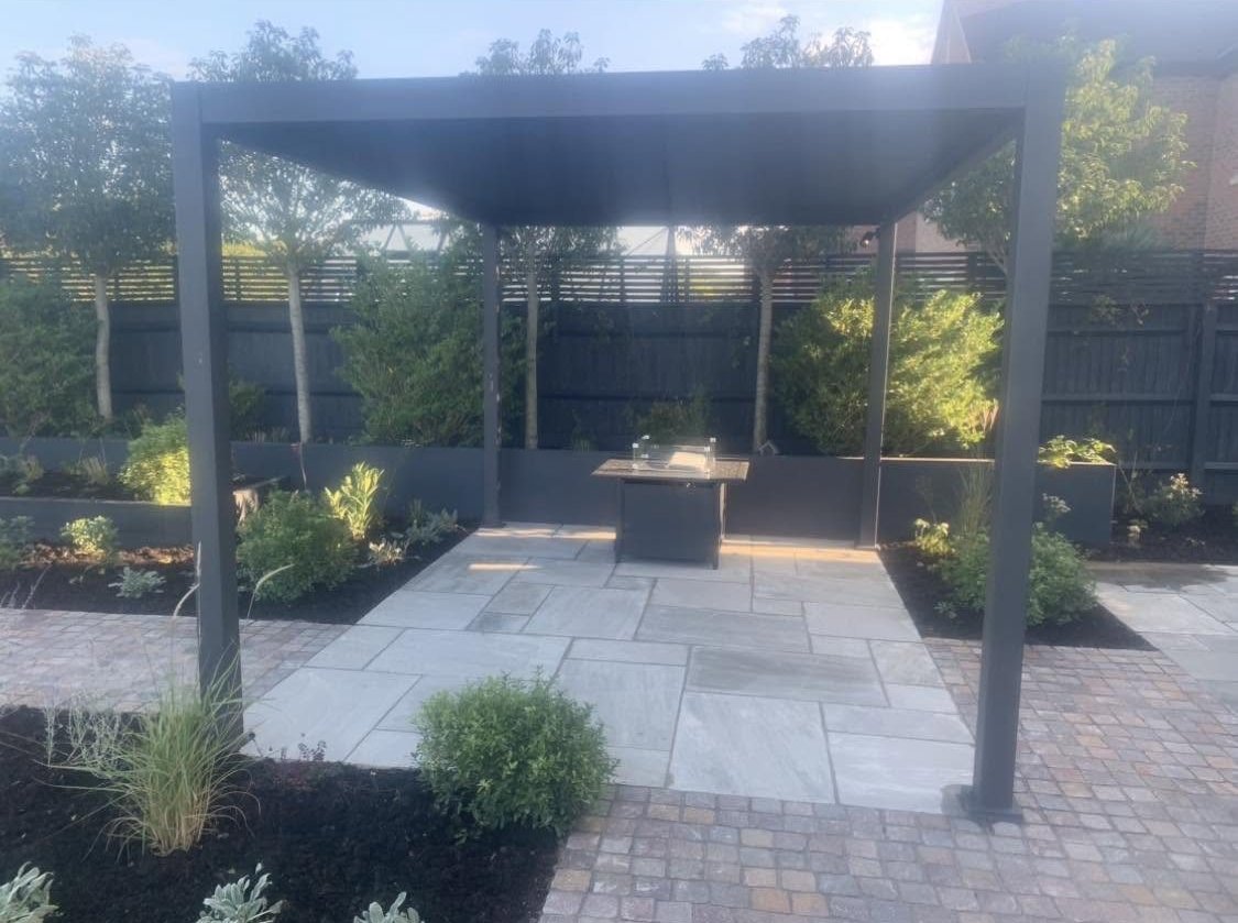 Sandstone patio under a pergola in Weston Turville